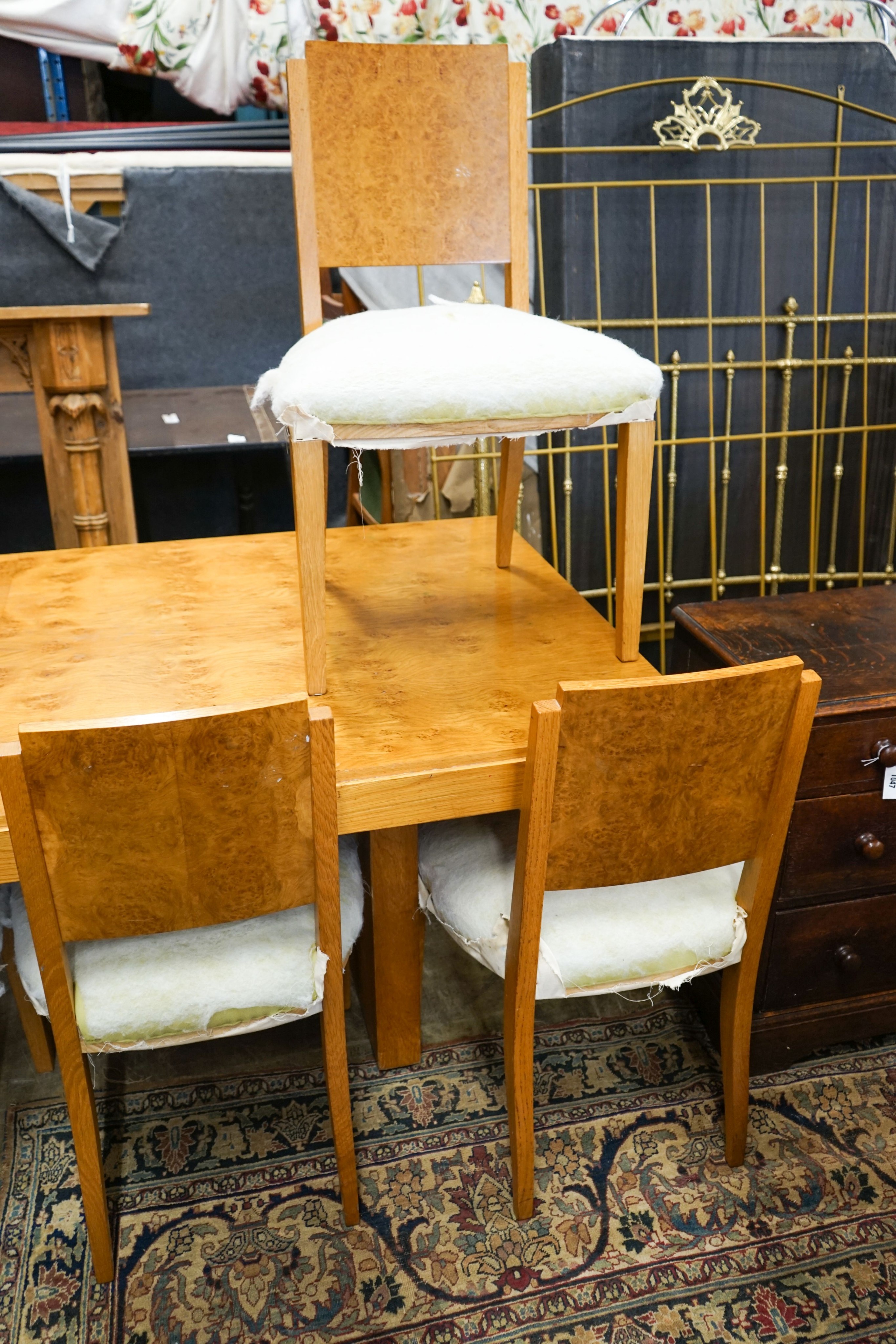 An Art Deco style bird's eye maple dining suite comprising table, six chairs and side cabinet, table length 200cm, width 104cm, height 72cm